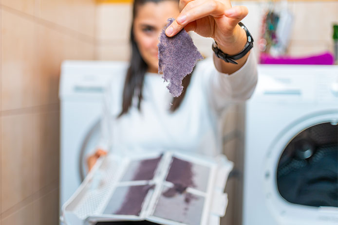 Woman holding up a piece of lint